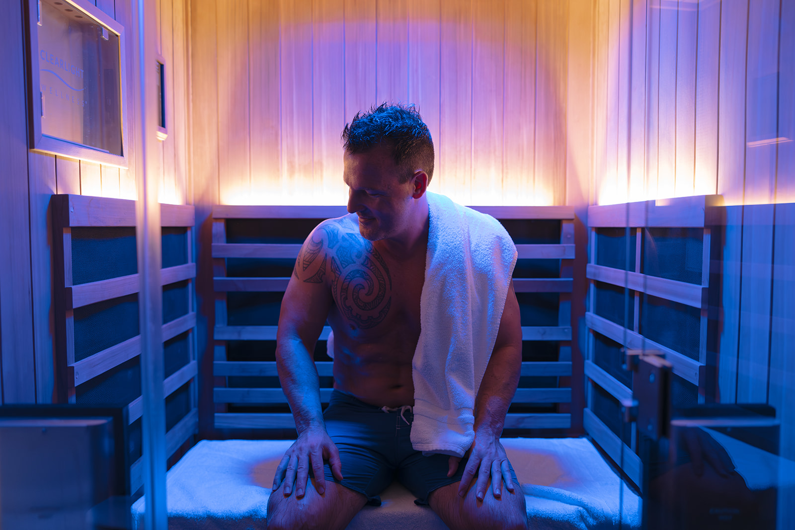 A man in an infrared sauna before a massage to loosen tight muscles and increase circulation.
